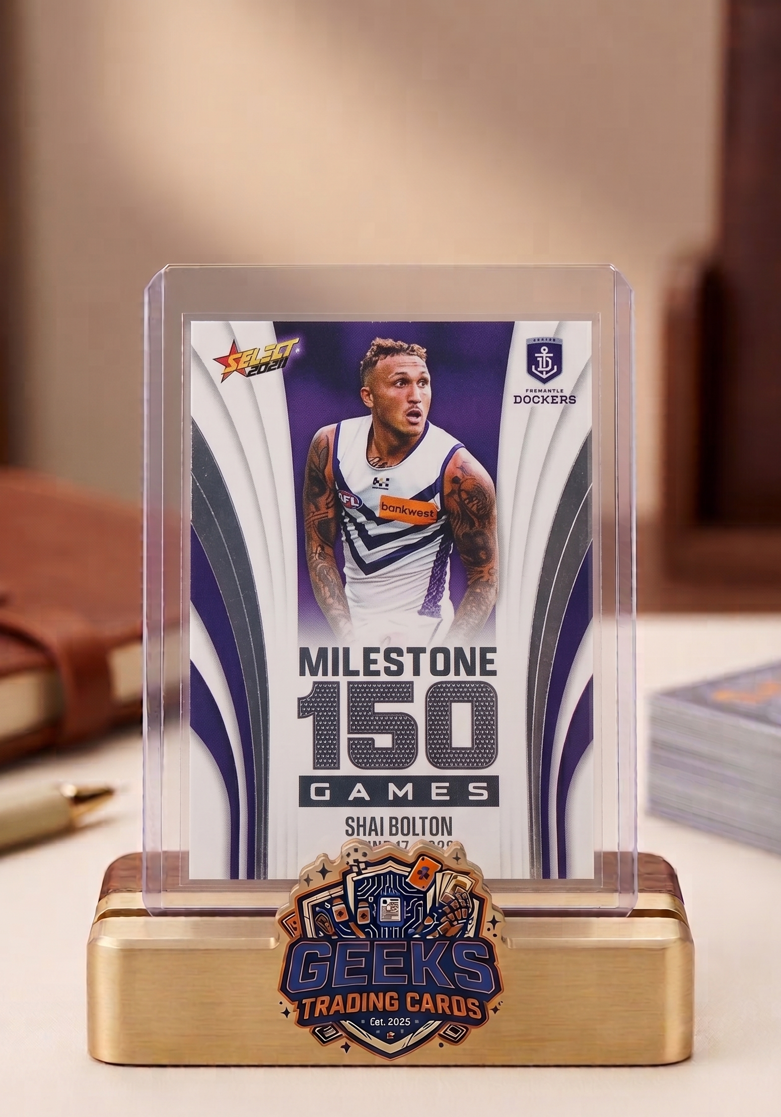 Trading card with a player's image and text on a display stand, featuring the Geeks Trading Cards logo.